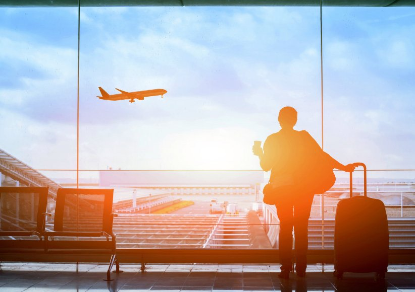 Traveller at an airport terminal at sunset