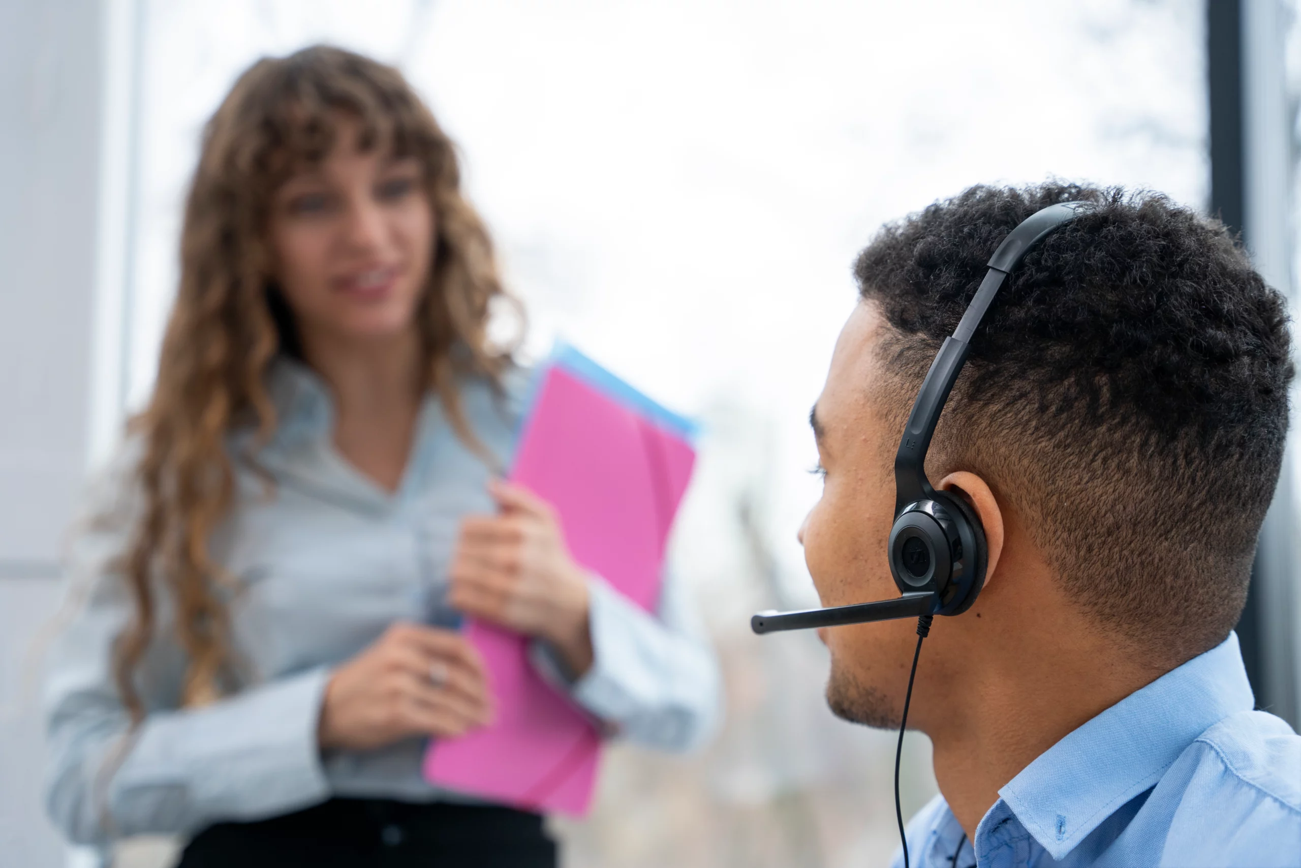 Customer service agent with a headset assisting a client