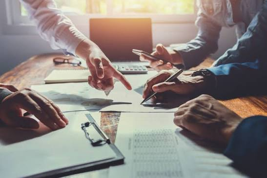 Finance professionals reviewing reports together